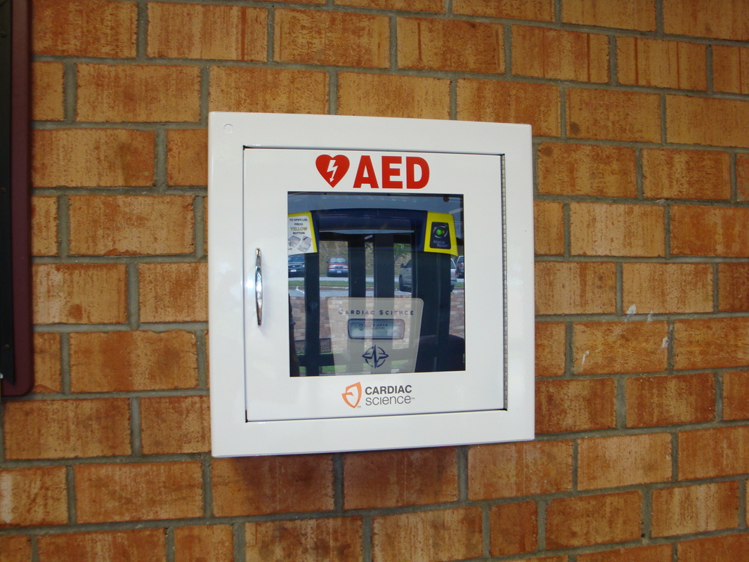 AED mounted on wall in SCHS Gym Home entrance lobby area