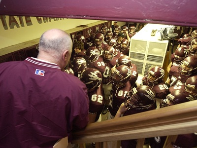 SCHS coach and football players in locker room